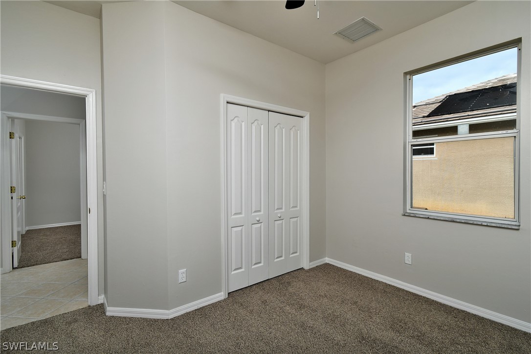 4612 Fairloop Run Lehigh Acres, FL 33973 - Photo 21 of 35 an empty room with windows and closet