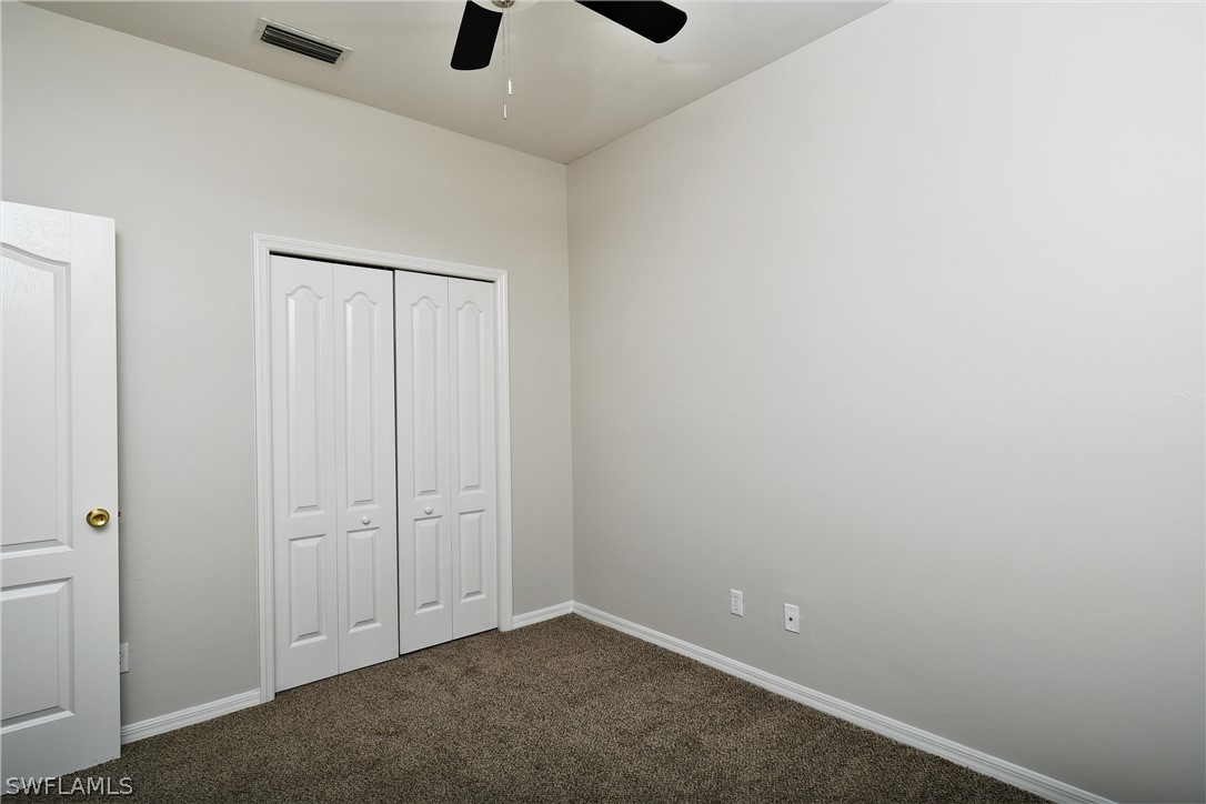 4612 Fairloop Run Lehigh Acres, FL 33973 - Photo 22 of 35 an empty room with windows