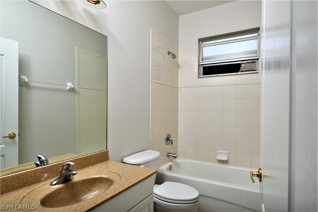 4612 Fairloop Run Lehigh Acres, FL 33973 - Photo 23 of 35 a bathroom with a sink a toilet and shower