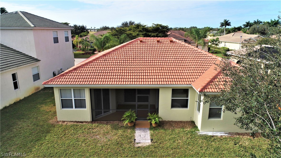 4612 Fairloop Run Lehigh Acres, FL 33973 - Photo 26 of 35 a front view of a house with garden
