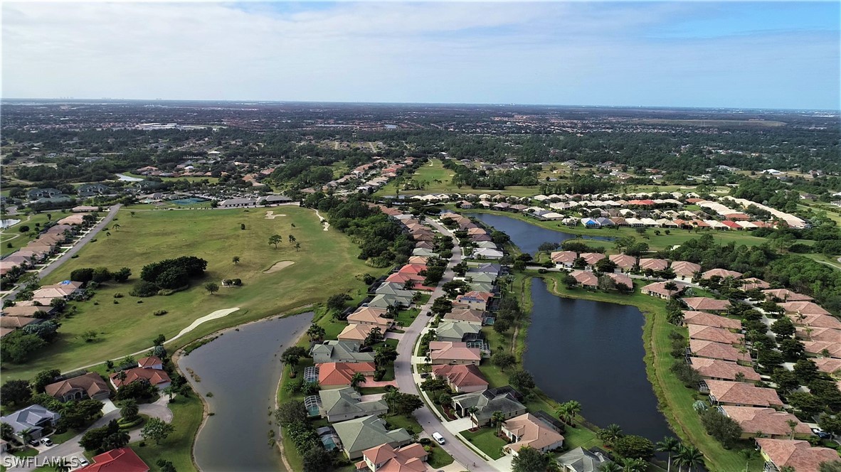 4612 Fairloop Run Lehigh Acres, FL 33973 - Photo 30 of 35 an aerial view of city lake and trees