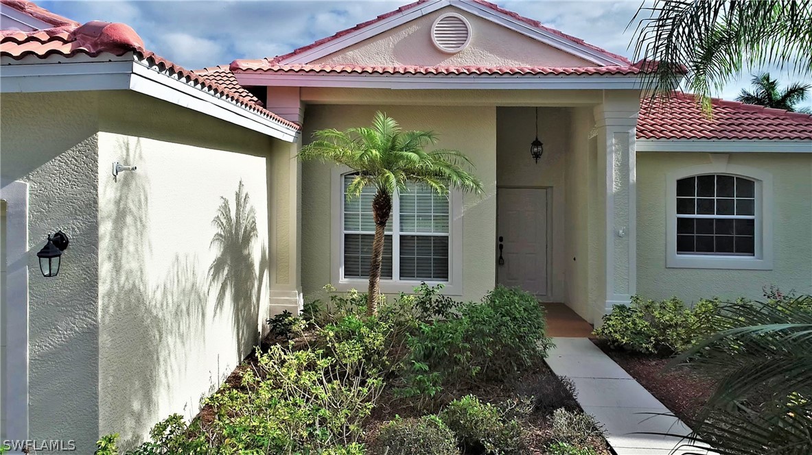 4612 Fairloop Run Lehigh Acres, FL 33973 - Photo 3 of 35 a front view of a house with a porch