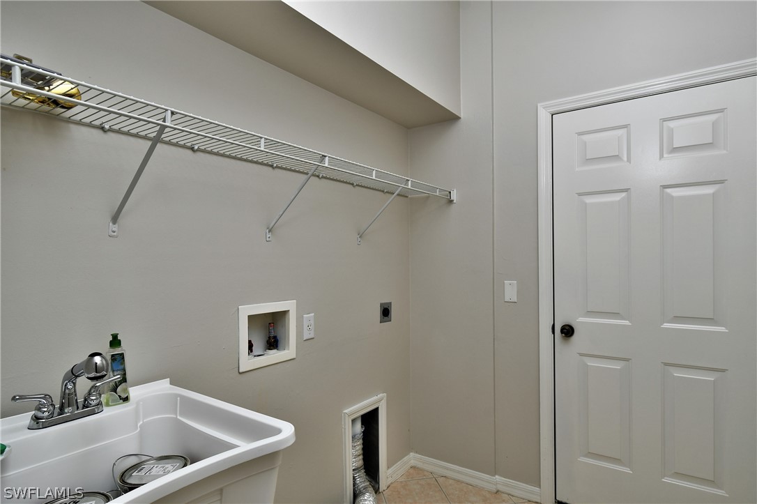 4612 Fairloop Run Lehigh Acres, FL 33973 - Photo 34 of 35 a bathroom with a tub and shower