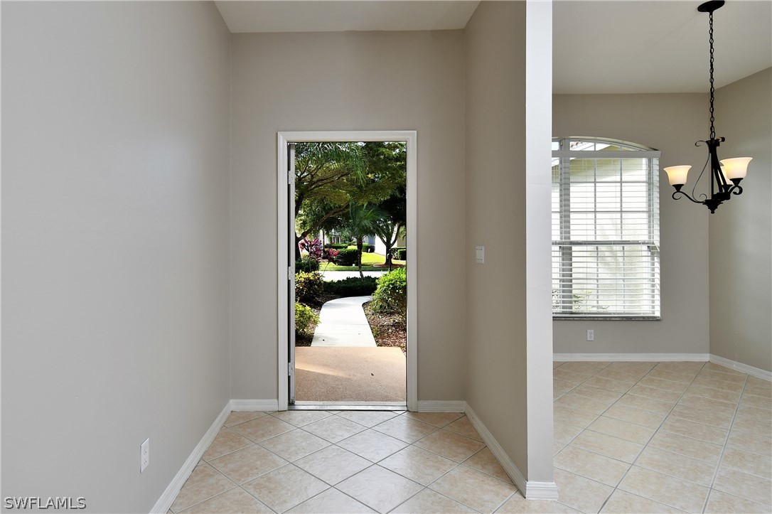4612 Fairloop Run Lehigh Acres, FL 33973 - Photo 4 of 35 a view of a hallway to a livingroom and a window