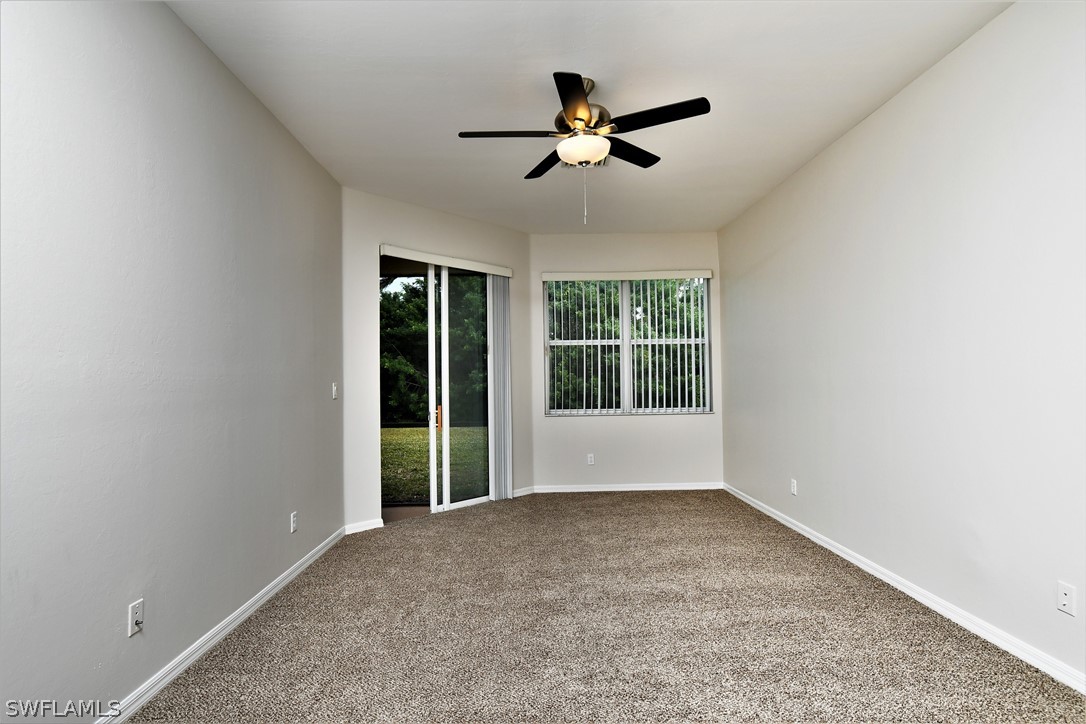 4612 Fairloop Run Lehigh Acres, FL 33973 - Photo 7 of 35 a view of a livingroom with a ceiling fan and window