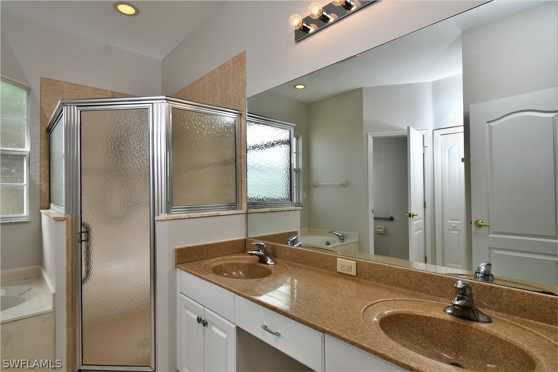 4612 Fairloop Run Lehigh Acres, FL 33973 - Photo 9 of 35 a bathroom with a sink and a mirror