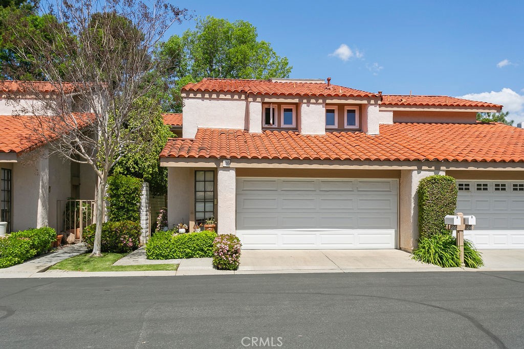 a front view of a house with a yard and a garage