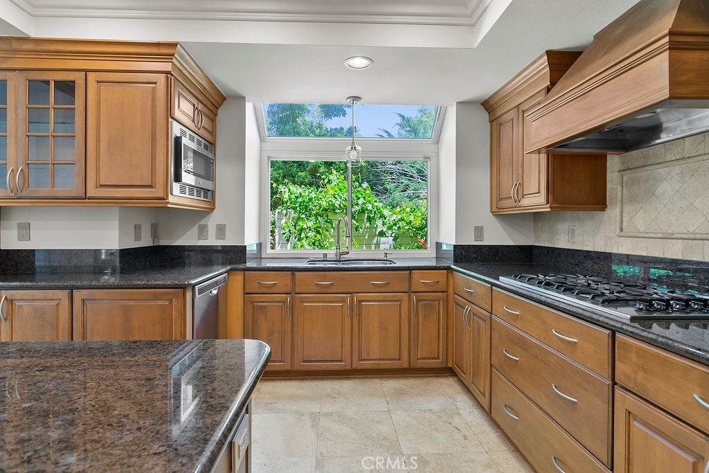 26 Tahoe Irvine, CA 92612 - Photo 19 of 40 a kitchen with stainless steel appliances granite countertop a stove a sink and a microwave