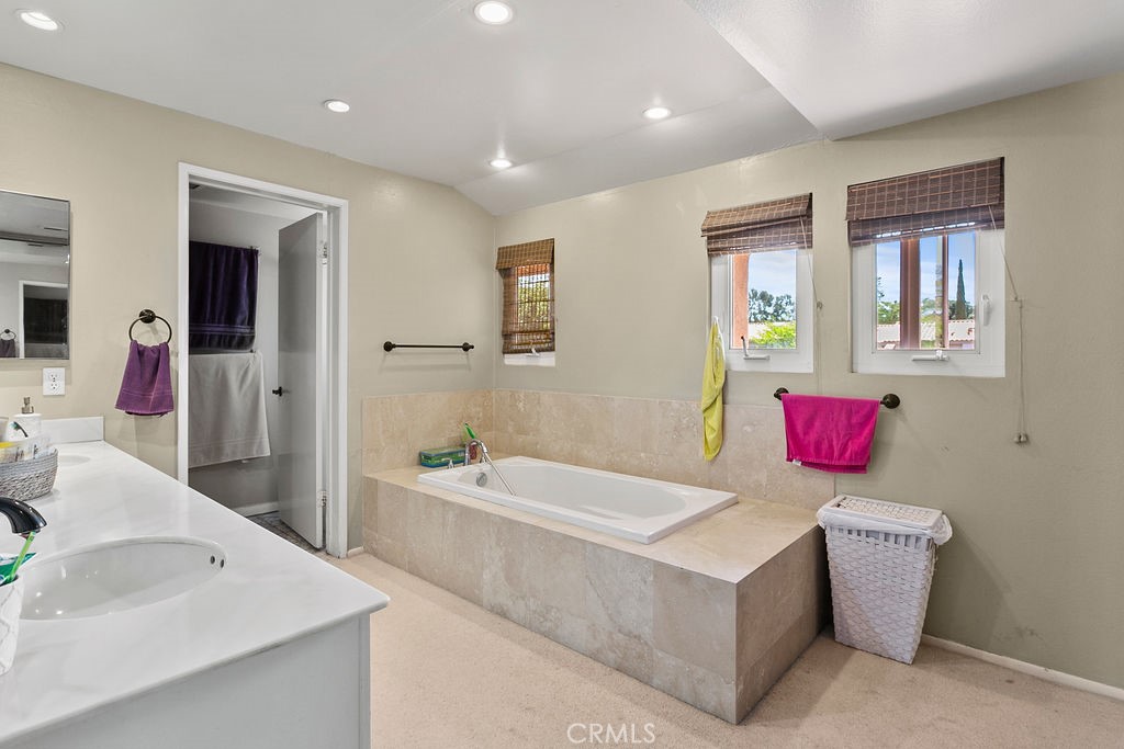 26 Tahoe Irvine, CA 92612 - Photo 23 of 40 a bathroom with a tub sink and mirror