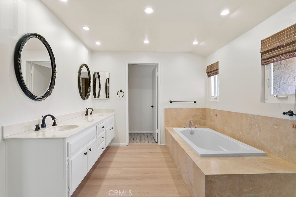 26 Tahoe Irvine, CA 92612 - Photo 24 of 40 a bathroom with a tub sink and mirror