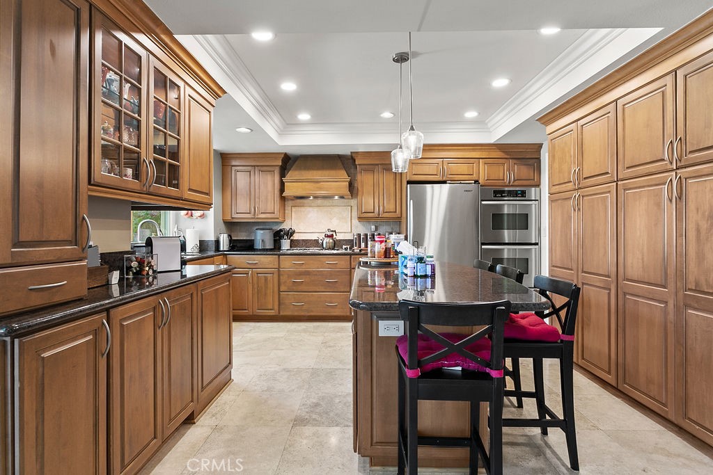 26 Tahoe Irvine, CA 92612 - Photo 3 of 40 a kitchen with stainless steel appliances granite countertop a refrigerator a sink dishwasher a dining table and chairs with wooden floor