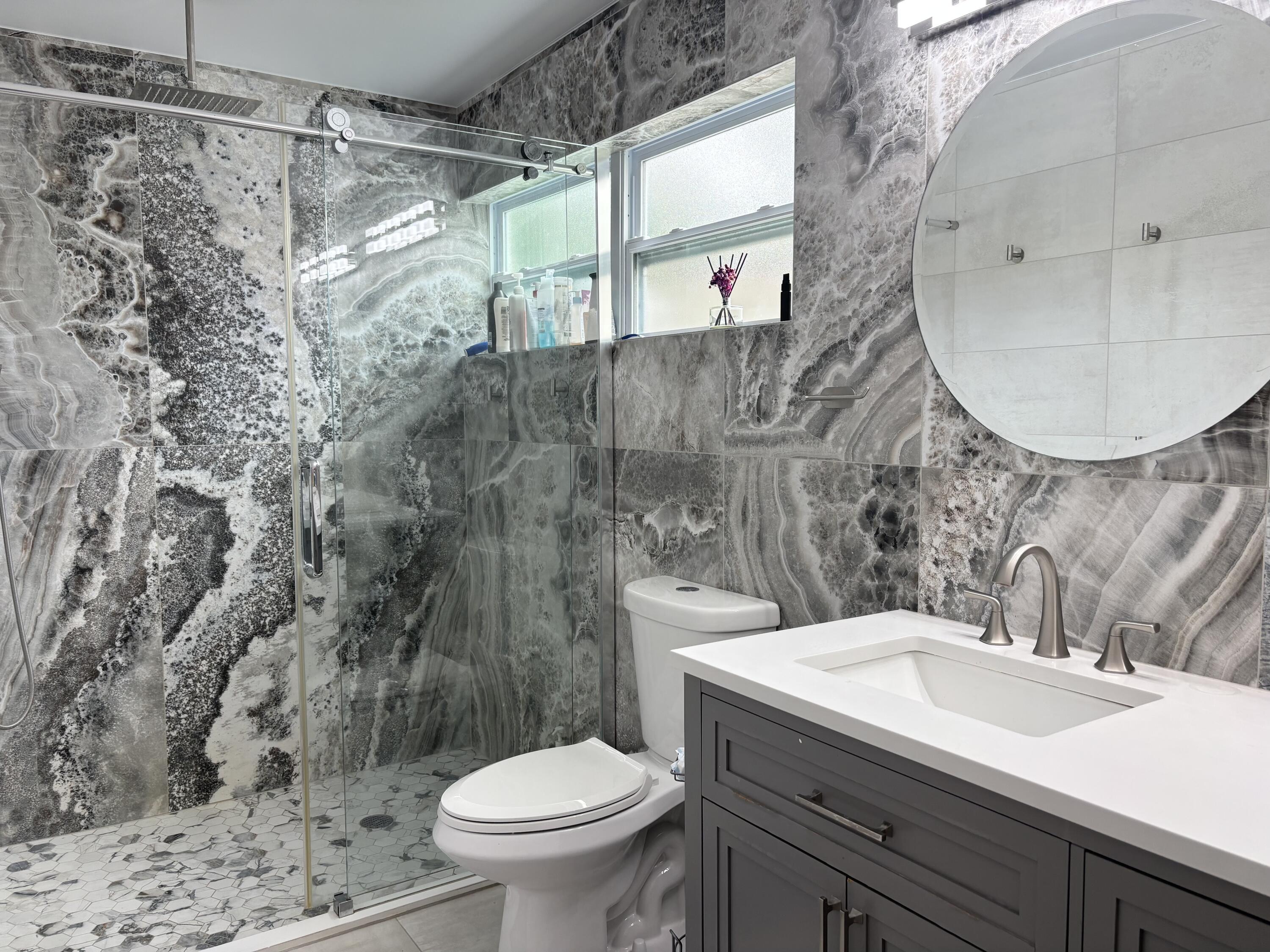 330 Sandalwood Lane Boca Raton, FL 33487 - Photo 13 of 23 a bathroom with a sink mirror vanity and toilet