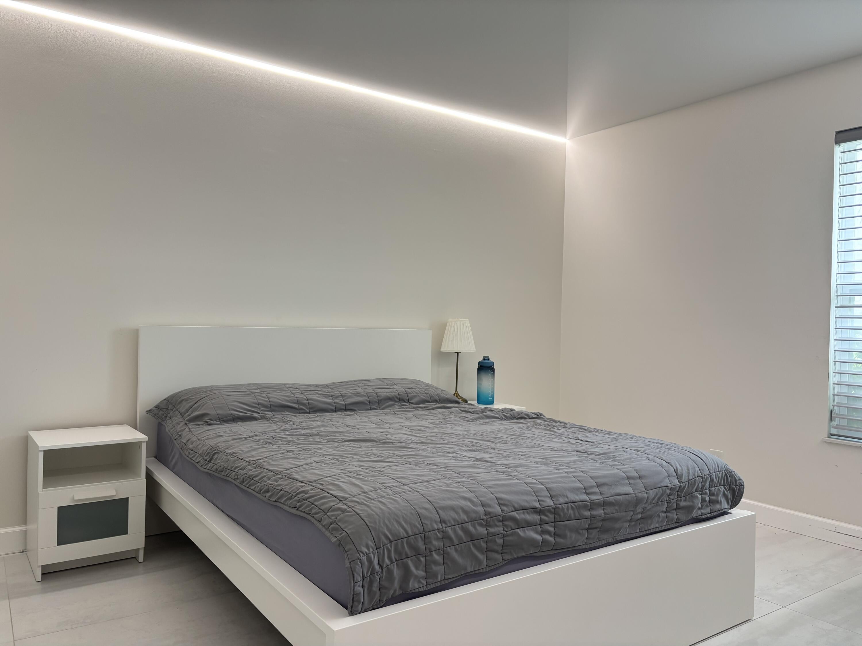 330 Sandalwood Lane Boca Raton, FL 33487 - Photo 15 of 23 a bedroom with a bed and cabinet