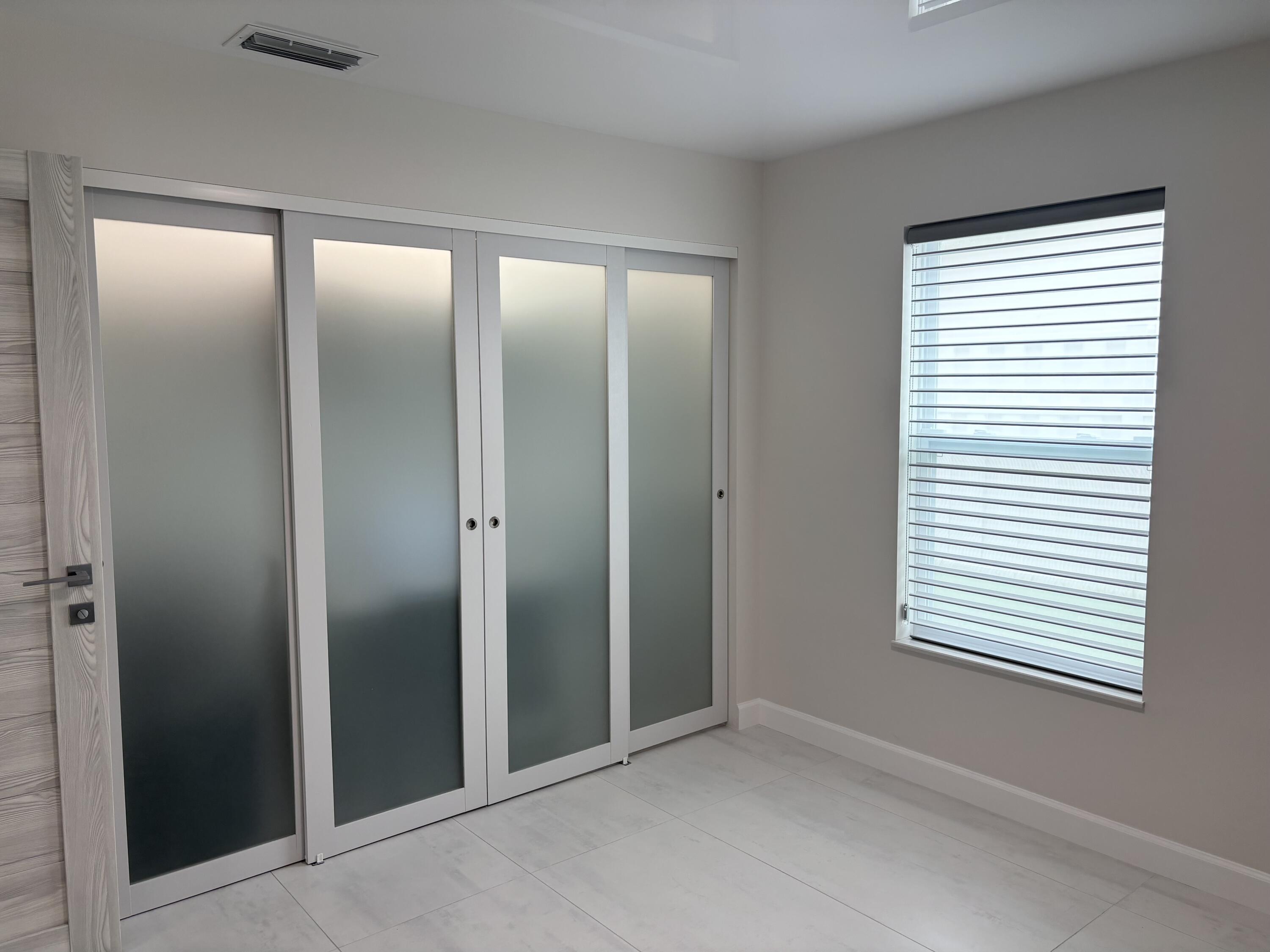 330 Sandalwood Lane Boca Raton, FL 33487 - Photo 18 of 23 an empty room that has a window in it