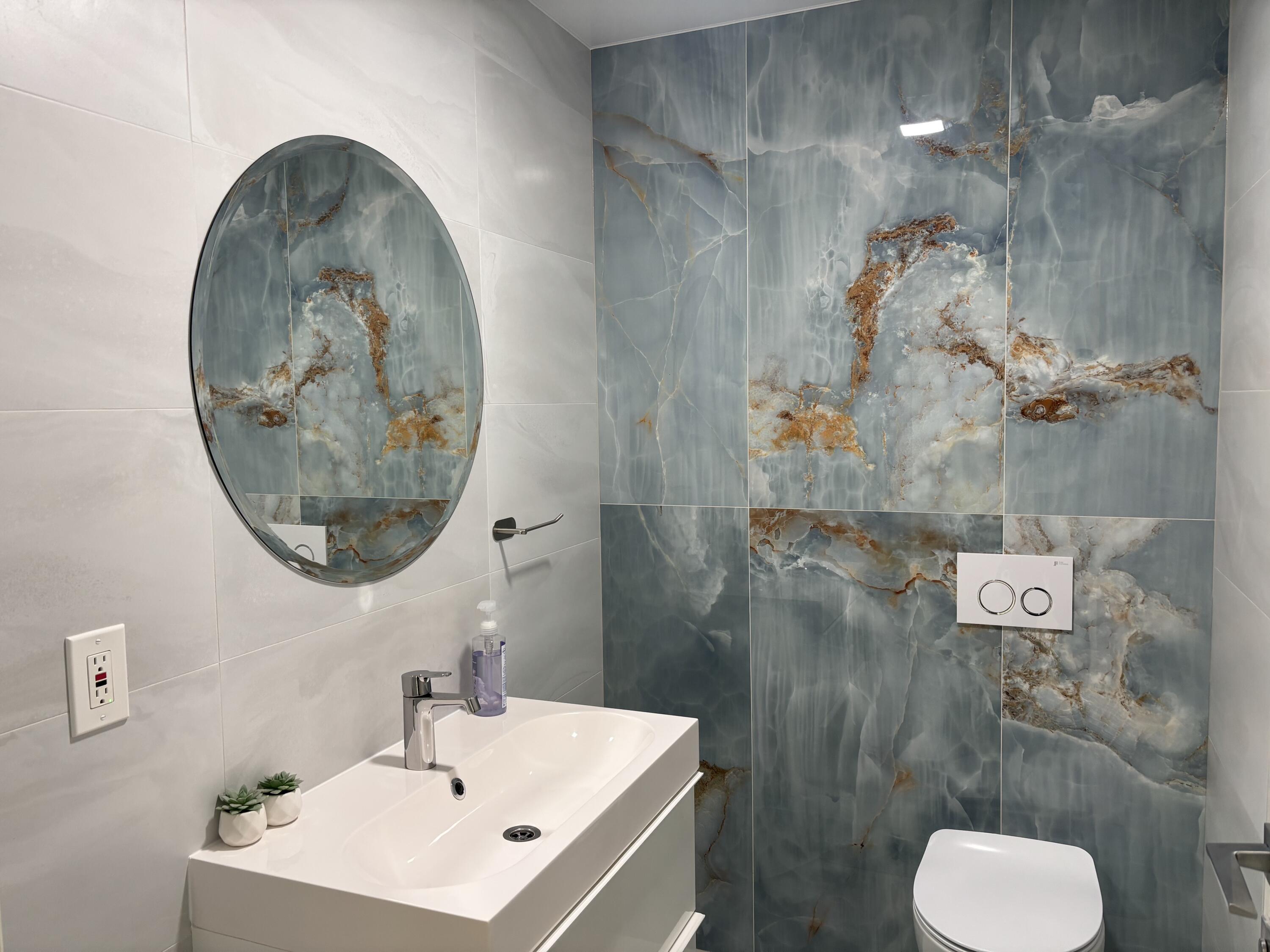 330 Sandalwood Lane Boca Raton, FL 33487 - Photo 19 of 23 a bathroom with a toilet sink and mirror