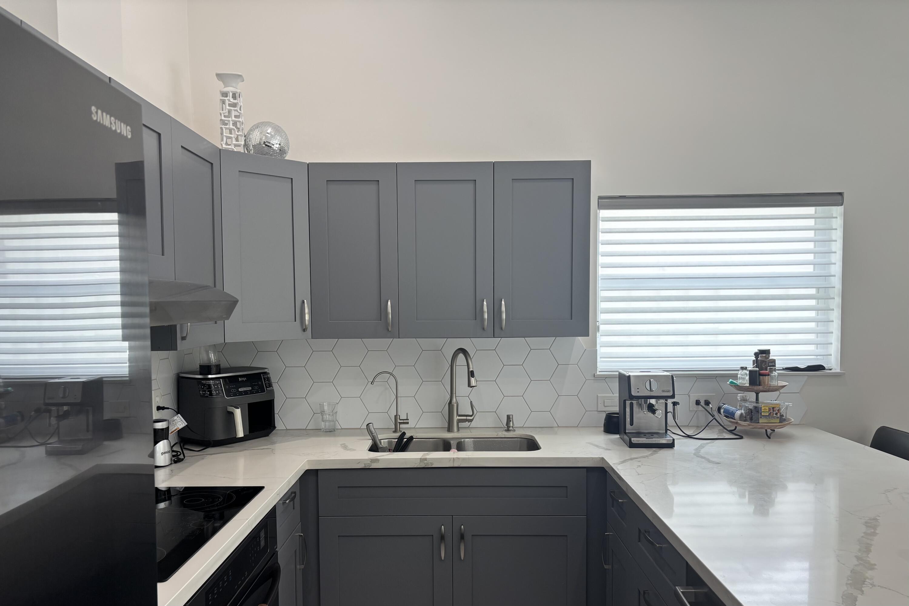 330 Sandalwood Lane Boca Raton, FL 33487 - Photo 4 of 23 a kitchen with a sink cabinets and window