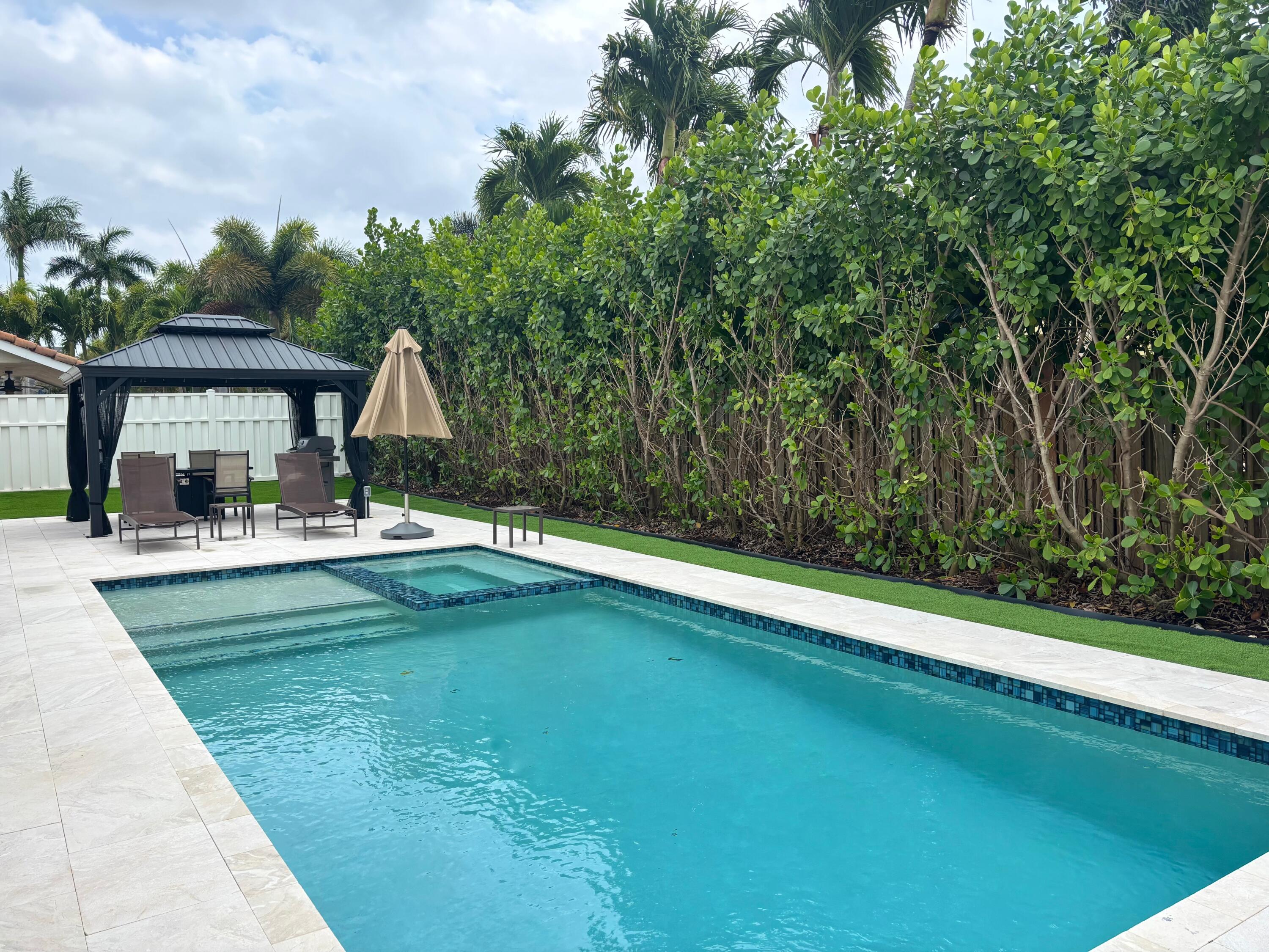 330 Sandalwood Lane Boca Raton, FL 33487 - Photo 8 of 23 a swimming pool with outdoor seating and yard