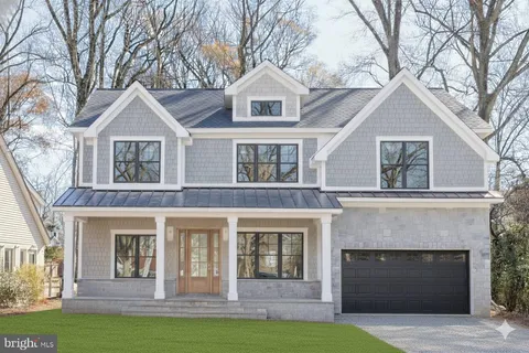 a front view of a house with yard and garage
