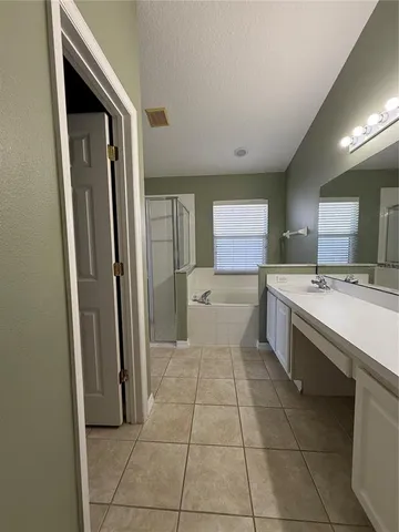 a large white kitchen with a sink and cabinets