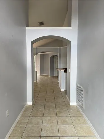 a view of a hallway to a livingroom with a fireplace