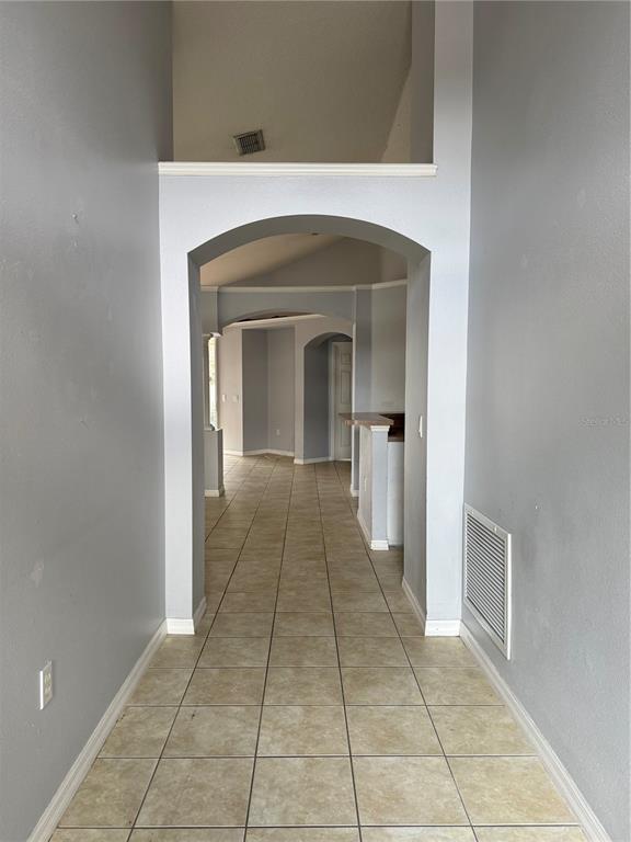 436 Saddle Ridge Drive Davenport, FL 33896 - Photo 3 of 35 a view of a hallway to a livingroom with a fireplace
