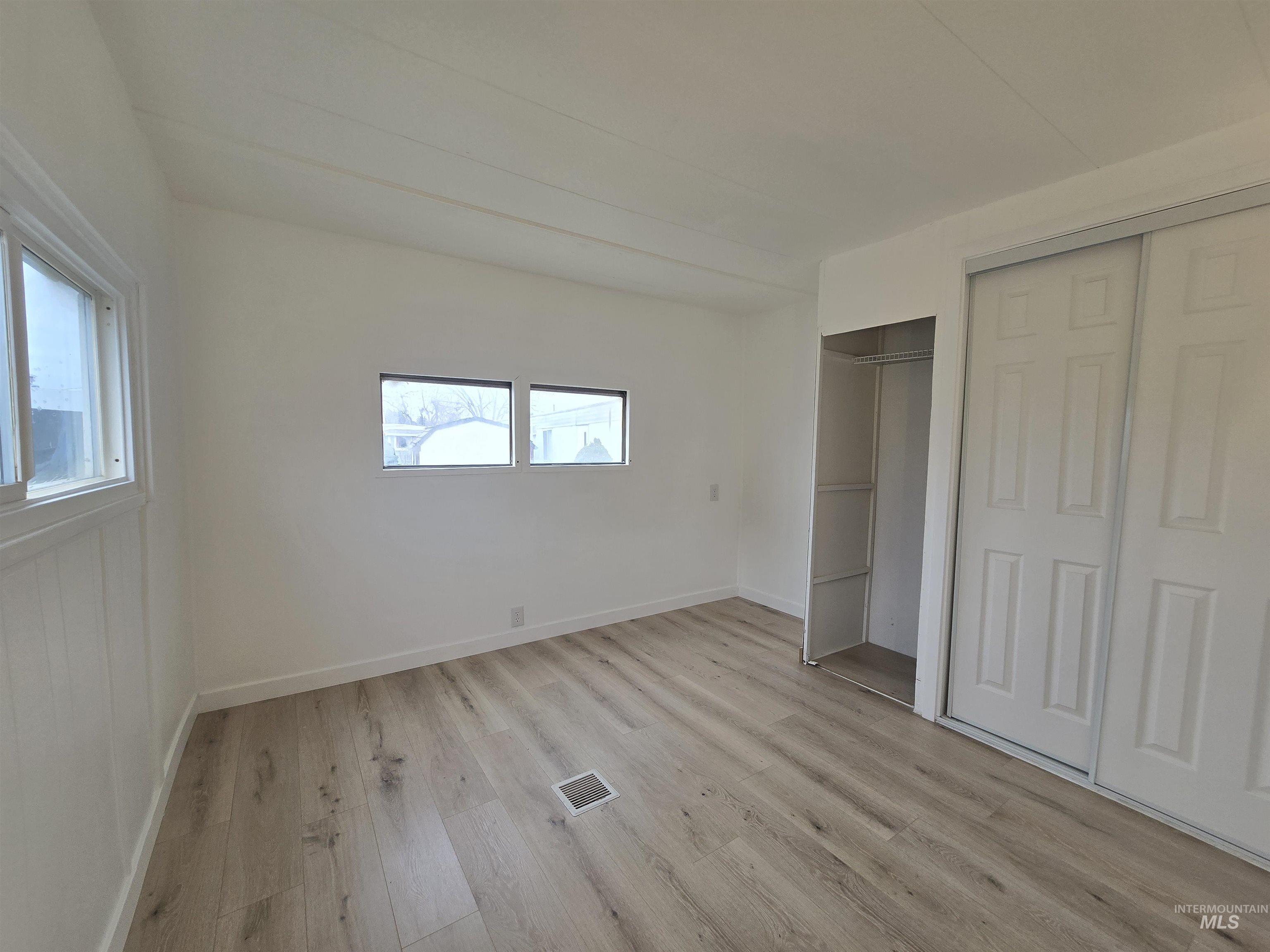 915 South Curtis Road, Unit 80 Boise, ID 83705 - Photo 7 of 12 Unfurnished bedroom with light wood-type flooring and a closet