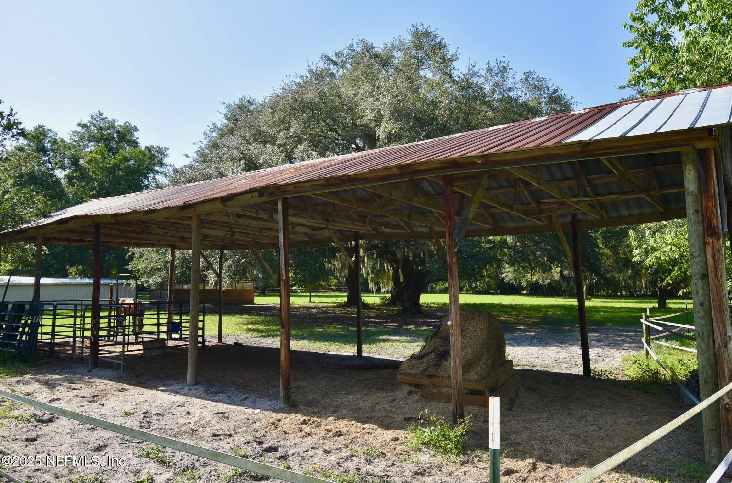 500 Georgetown Shortcut Road Georgetown, FL 32139 - Photo 18 of 59 a view of a patio with table and chairs under an umbrella