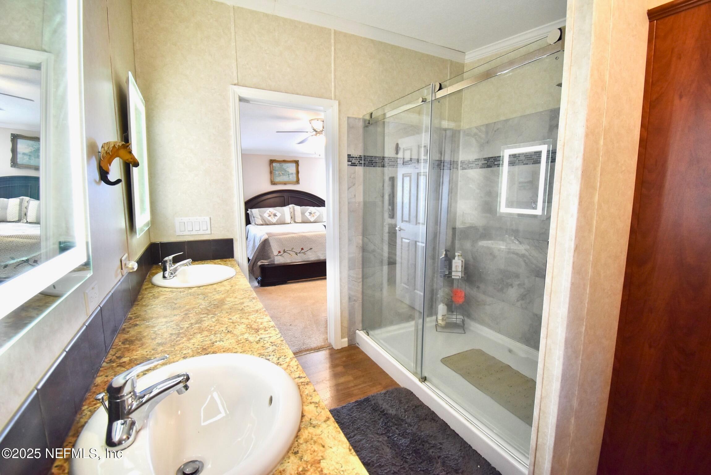 500 Georgetown Shortcut Road Georgetown, FL 32139 - Photo 36 of 59 a en suite bathroom with a granite countertop sink and a mirror