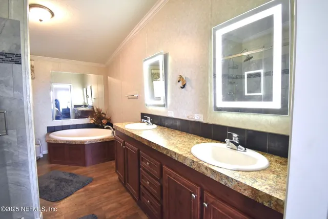 a bedroom with bed and wooden floor