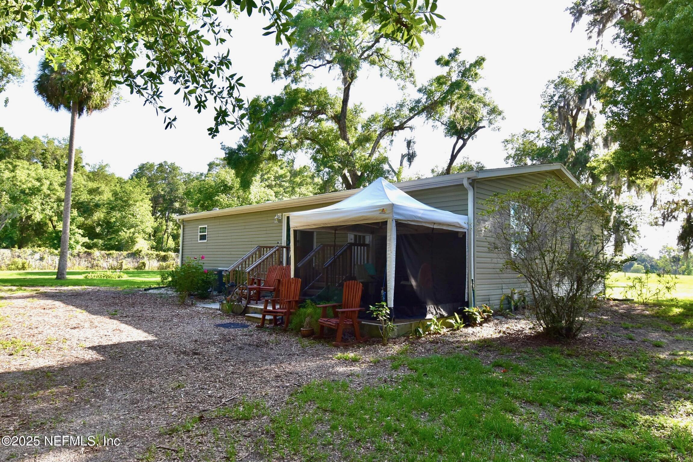 500 Georgetown Shortcut Road Georgetown, FL 32139 - Photo 4 of 59 a view of a chair and table in backyard of the house