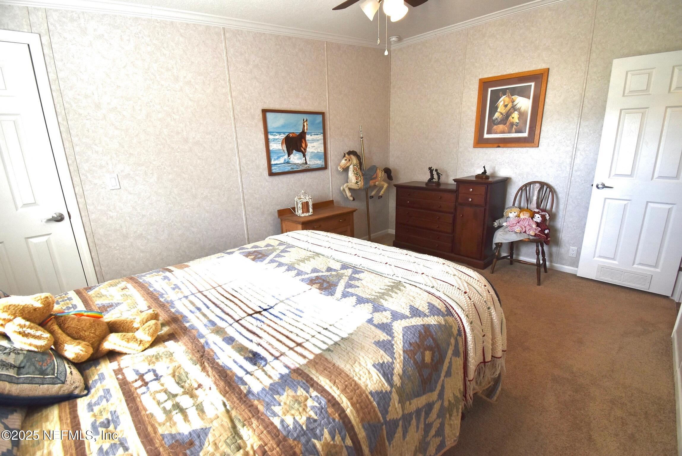 500 Georgetown Shortcut Road Georgetown, FL 32139 - Photo 42 of 59 a bedroom with a bed and a dresser