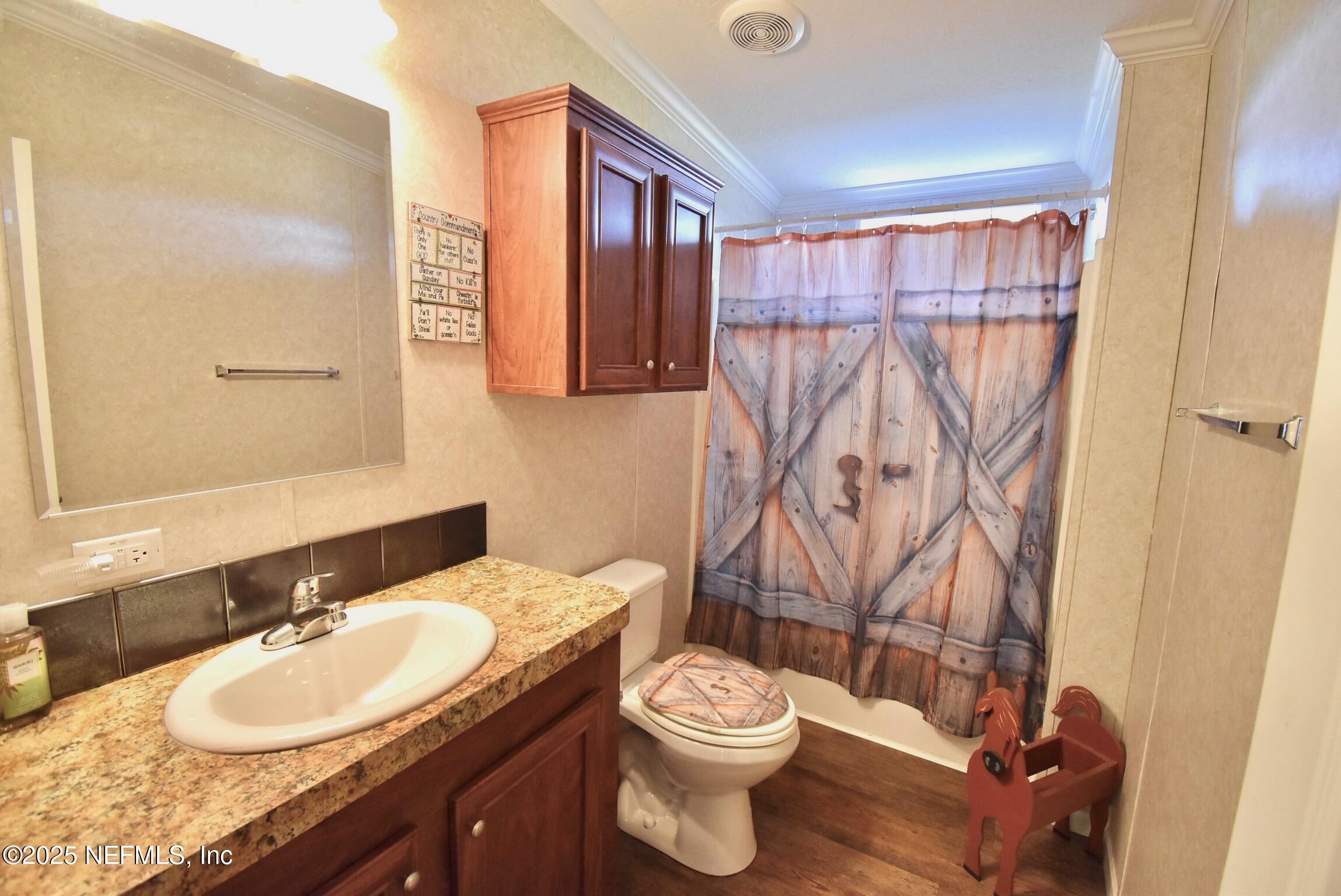 500 Georgetown Shortcut Road Georgetown, FL 32139 - Photo 45 of 59 a bathroom with a granite countertop sink toilet and a mirror