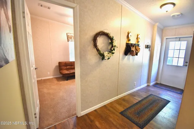 a view of a house with yard and a tree