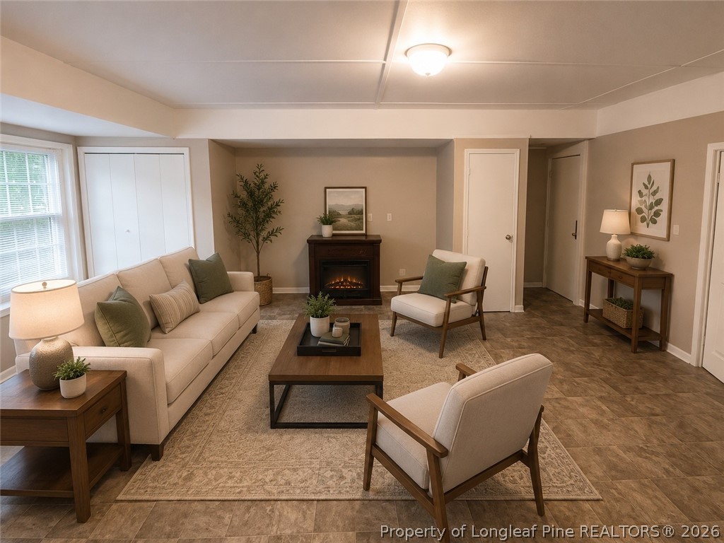 1404 Hibiscus Road Fayetteville, NC 28311 - Photo 6 of 10 a living room with furniture and a wooden floor