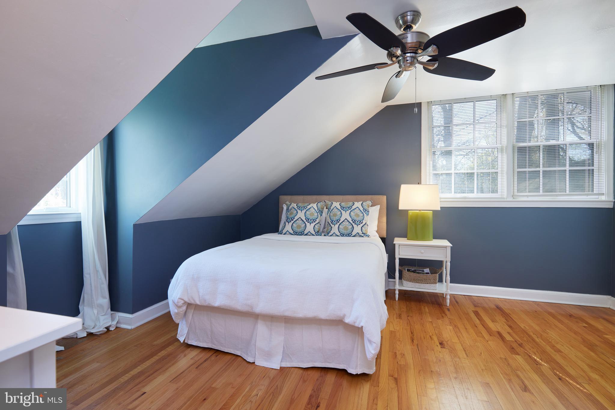 9604 Old Spring Road Kensington, MD 20895 - Photo 35 of 80 a spacious bedroom with a bed and a table
