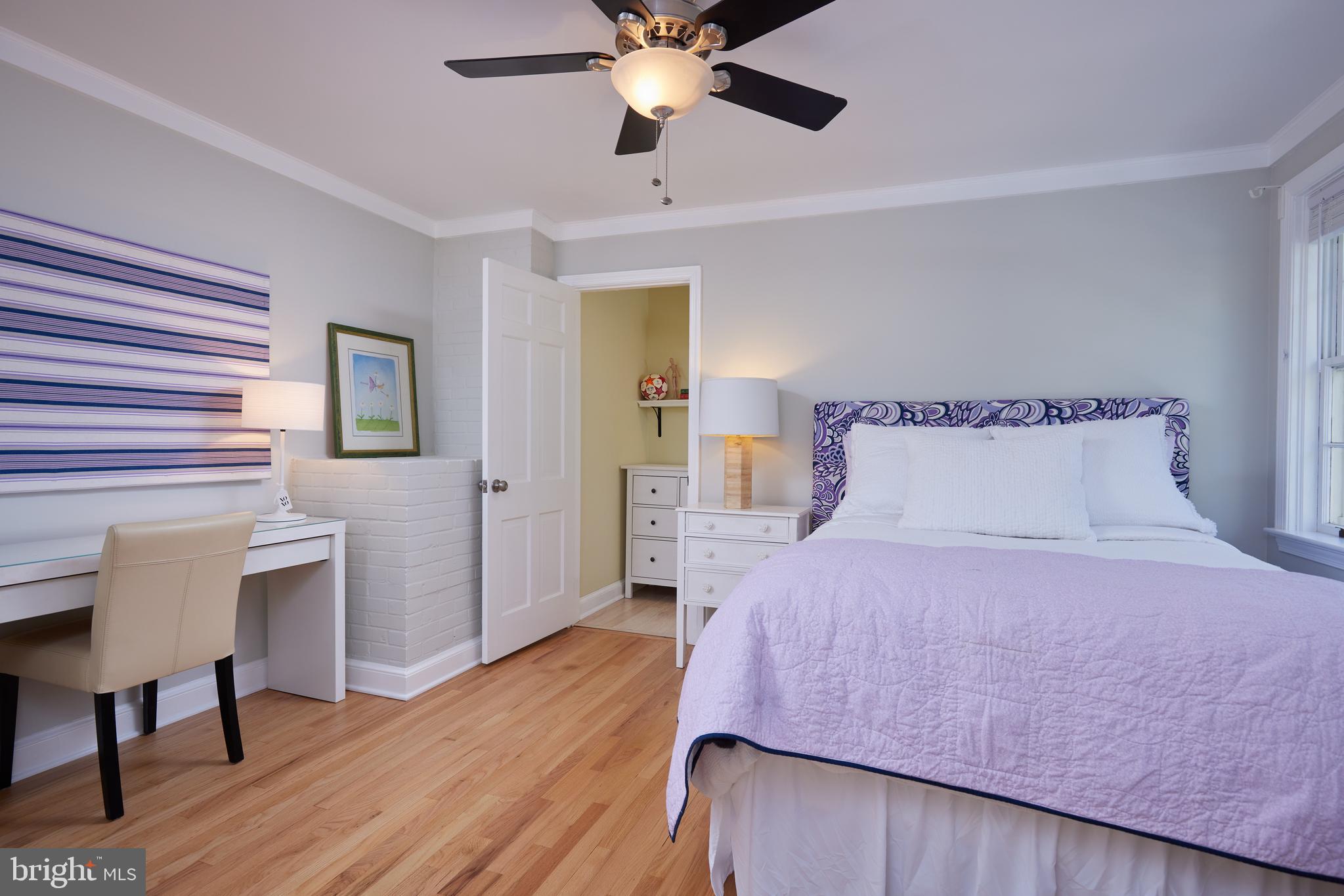 9604 Old Spring Road Kensington, MD 20895 - Photo 40 of 80 a bedroom with a bed and a chandelier