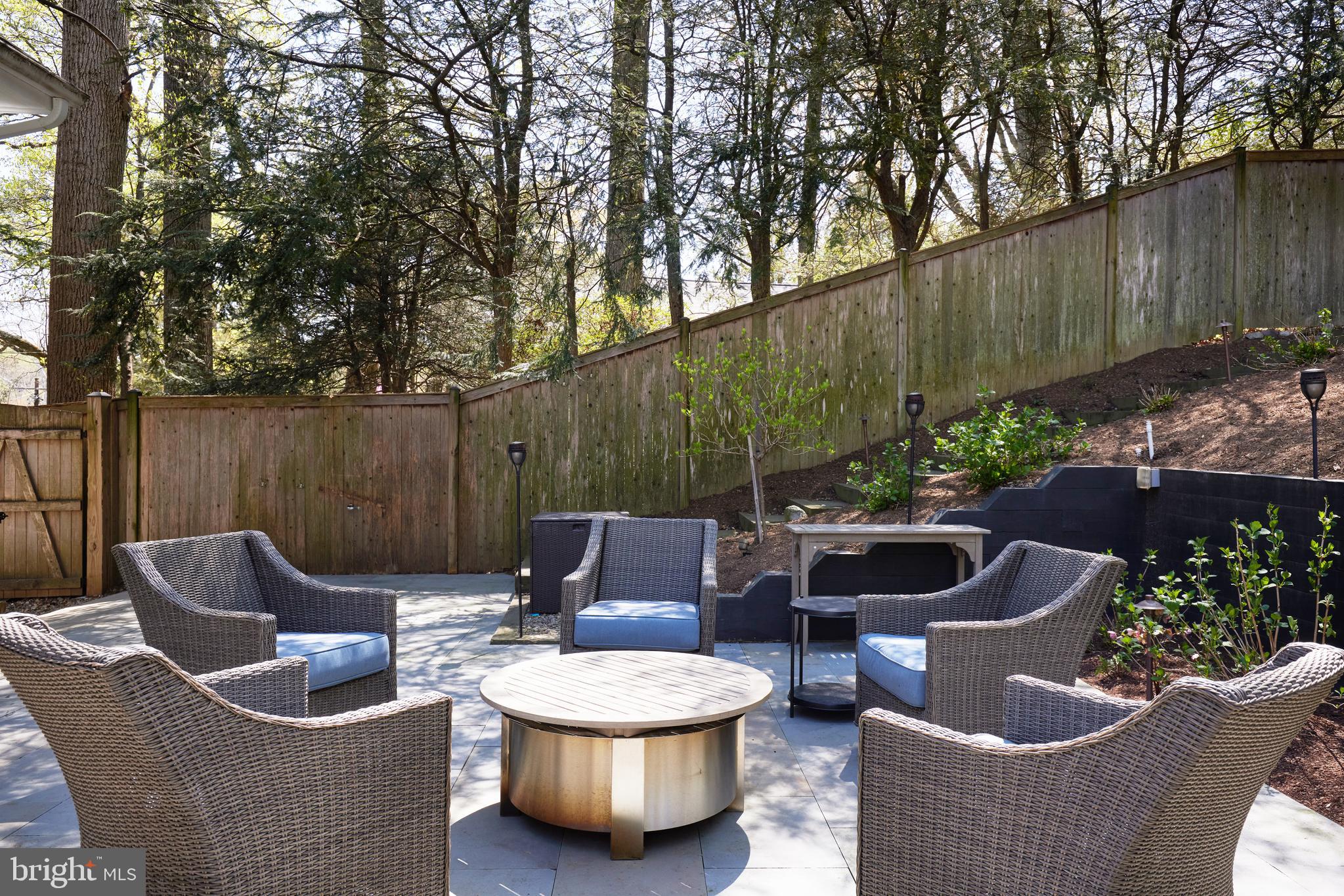 9604 Old Spring Road Kensington, MD 20895 - Photo 59 of 80 a view of a patio with couches chairs and a potted plant
