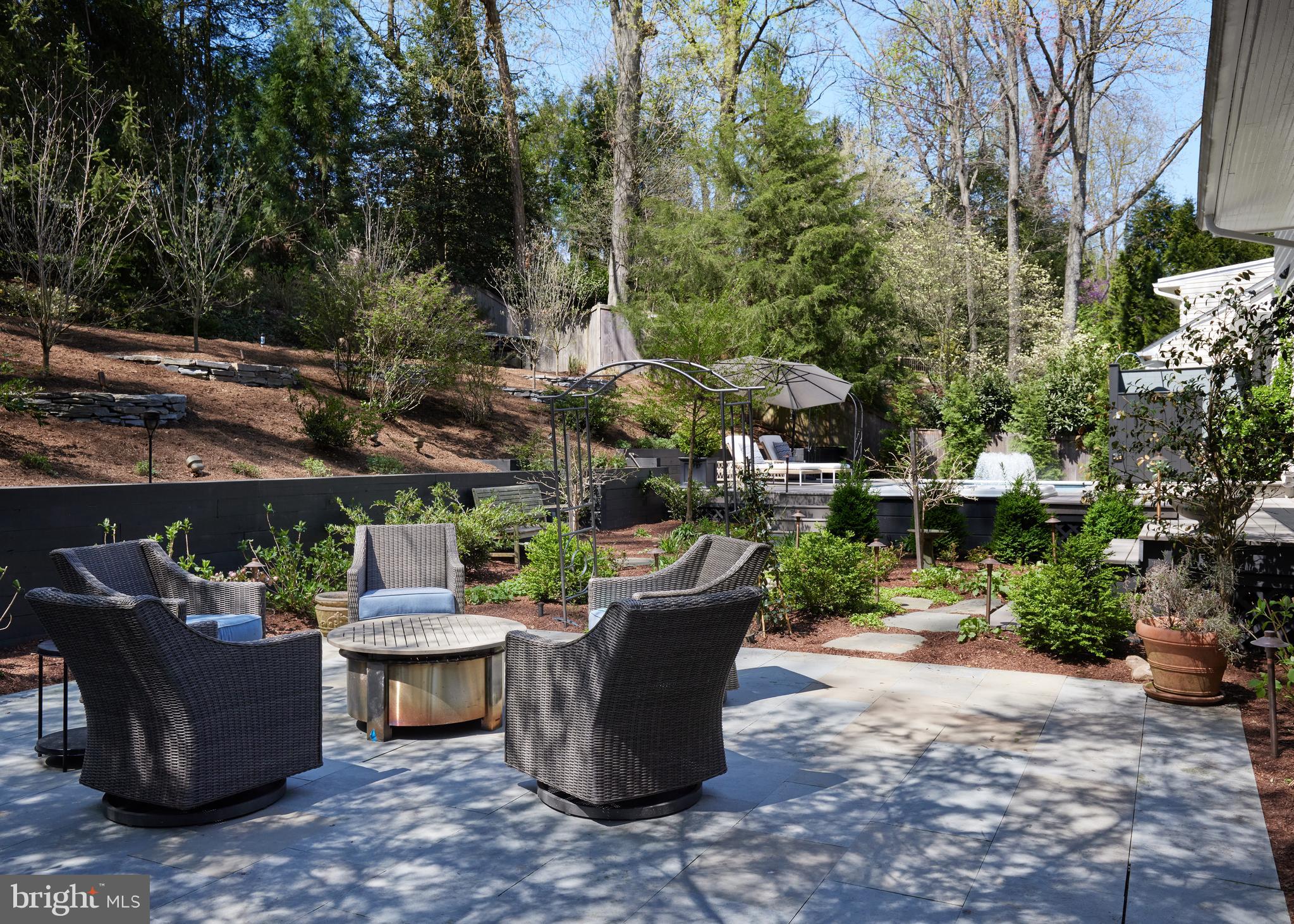 9604 Old Spring Road Kensington, MD 20895 - Photo 62 of 80 a view of a patio with table and chairs potted plants and large trees