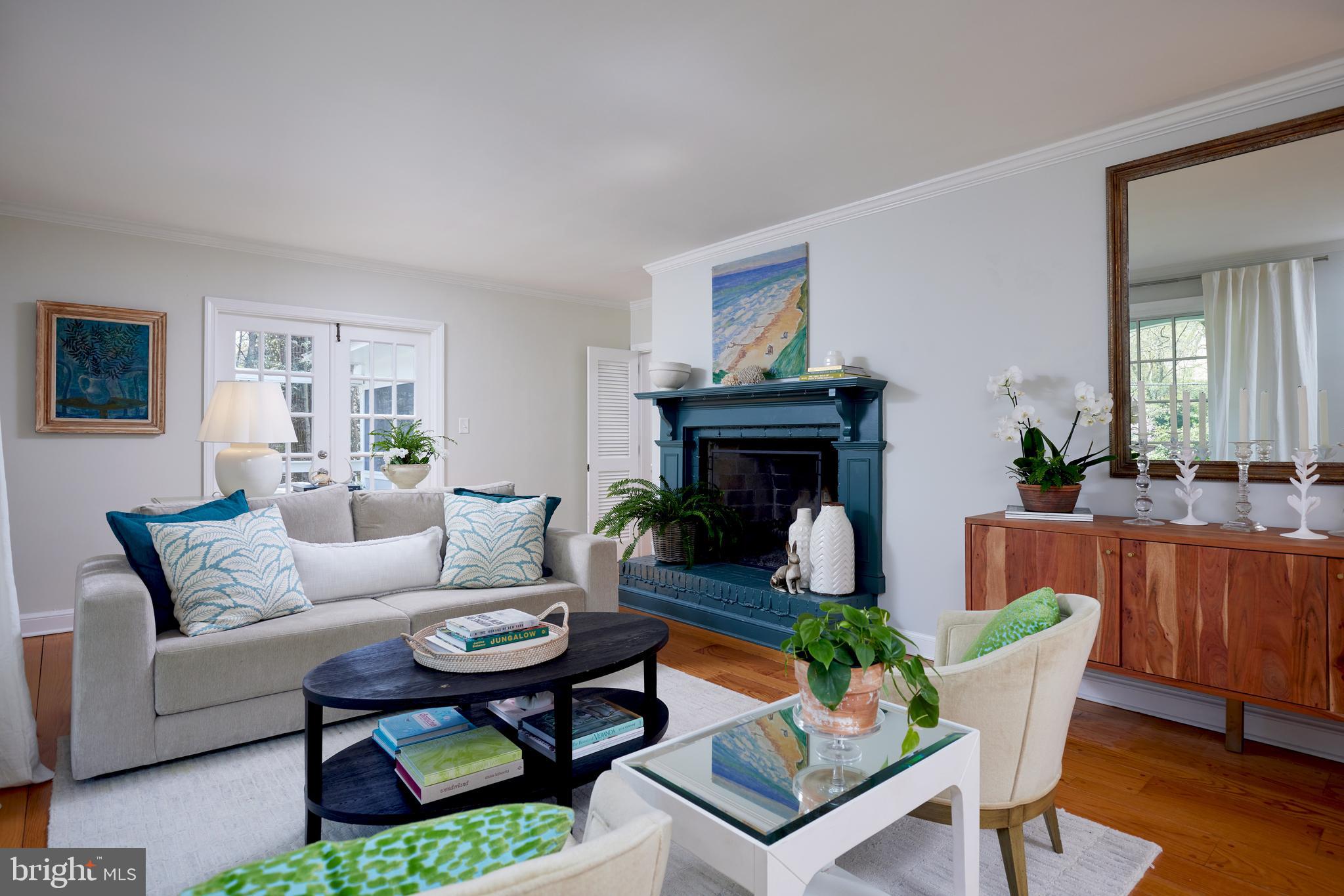 9604 Old Spring Road Kensington, MD 20895 - Photo 9 of 80 a living room with furniture a fireplace and a table