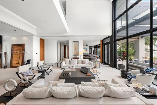 a living room with furniture and large windows
