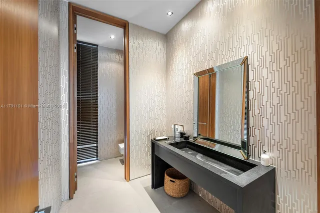 a room with a bed and large windows