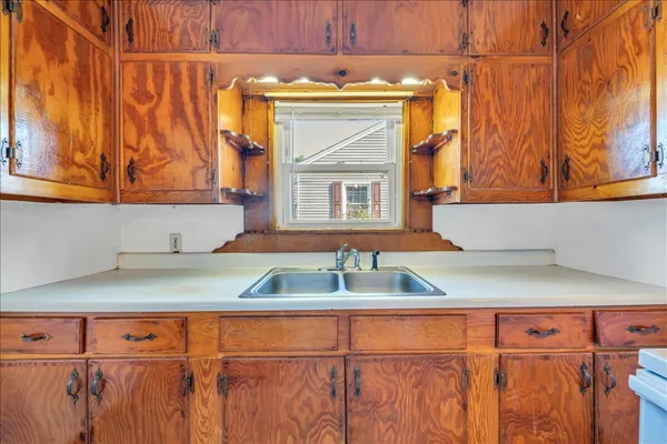 a kitchen with a refrigerator and a sink