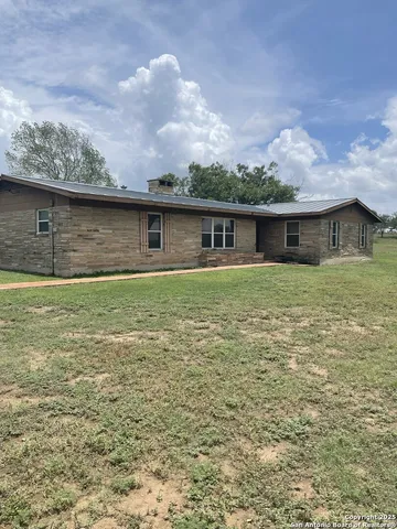 a front view of house with yard and trees