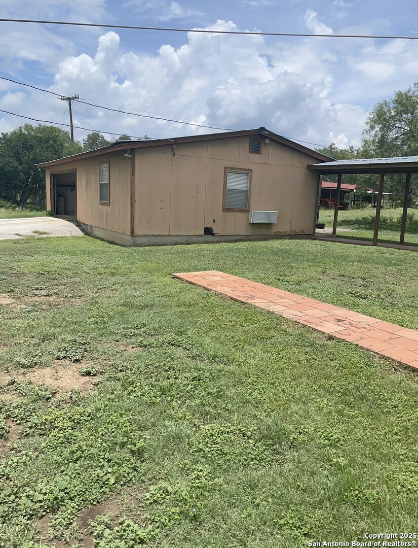 19512 Tonkawa Pass Garden Ridge, TX 78266 - Photo 2 of 6 a front view of house with yard and garage