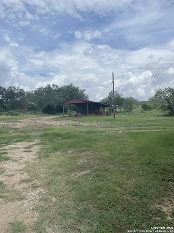 a view of a field with an ocean