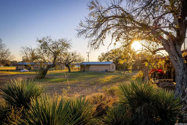 a view of a house with a yard and mountain view