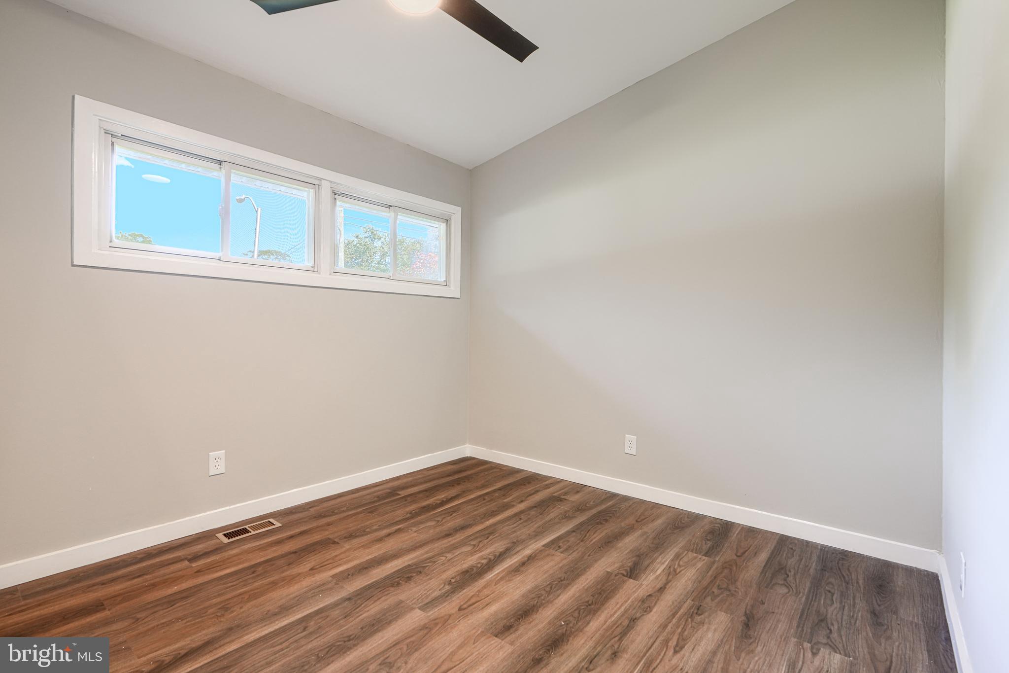 6200 Ivymount Road Baltimore, MD 21209 - Photo 29 of 71 a view of a room with wooden floor and windows