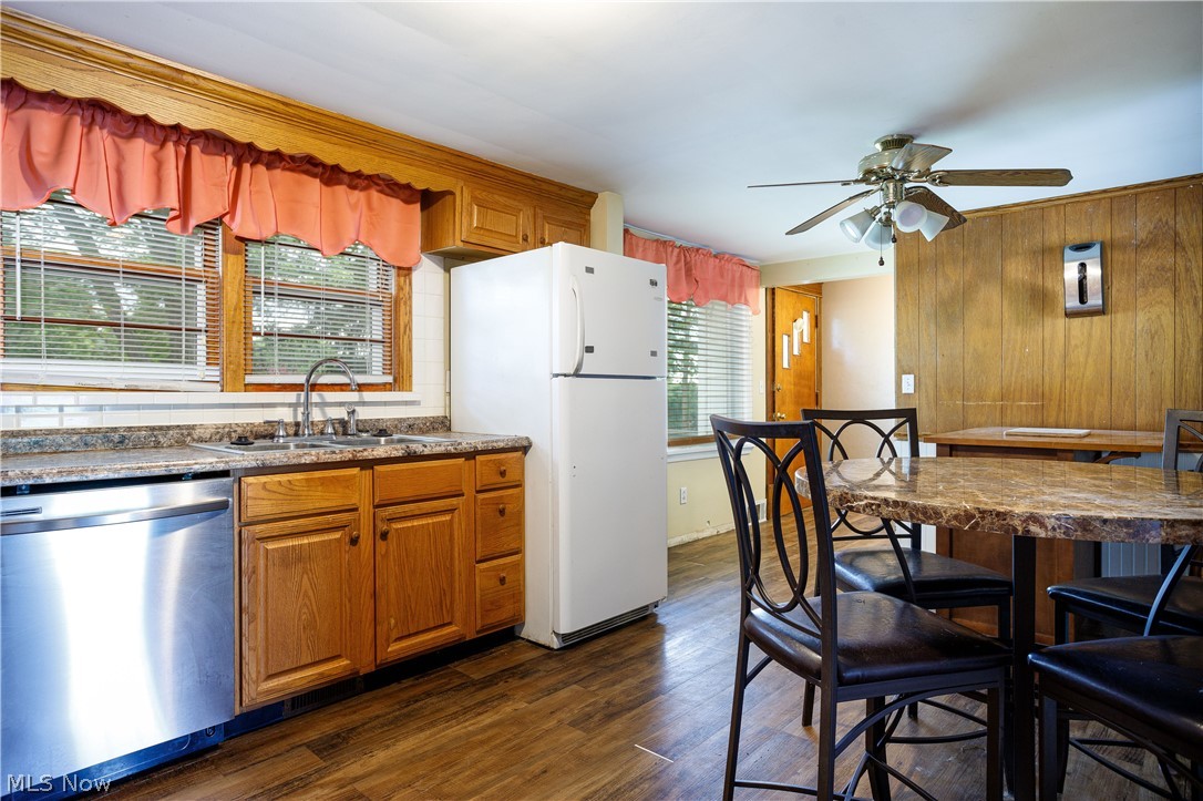 254 Johnson Road Wadsworth, OH 44281 - Photo 14 of 35 Kitchen with white refrigerator, dark hardwood / wood-style floors, ceiling fan, stainless steel dishwasher, and sink