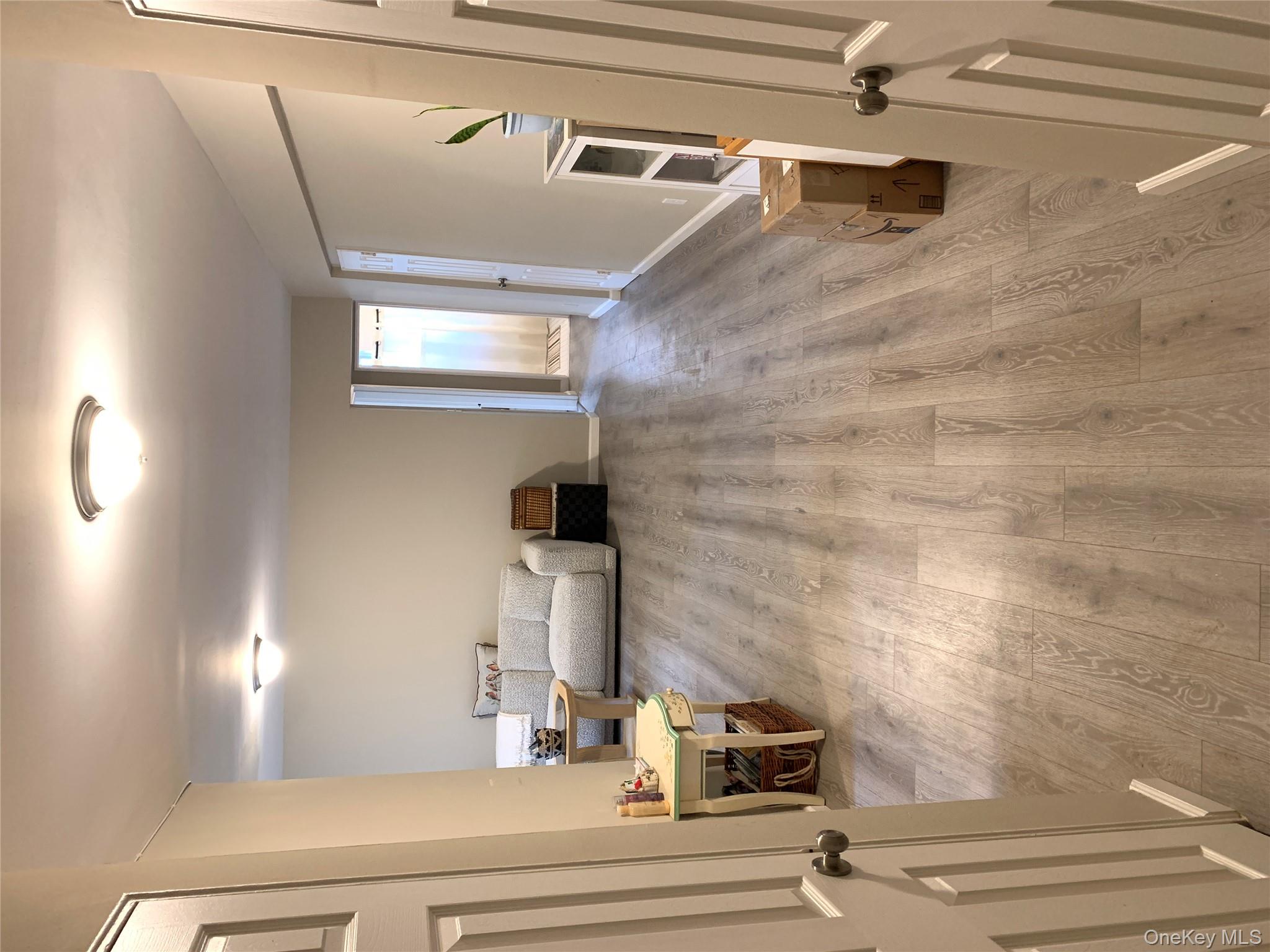 30 Davenport Avenue, Unit 1B New Rochelle, NY 10805 - Photo 3 of 16 a living room with furniture and a wooden floor