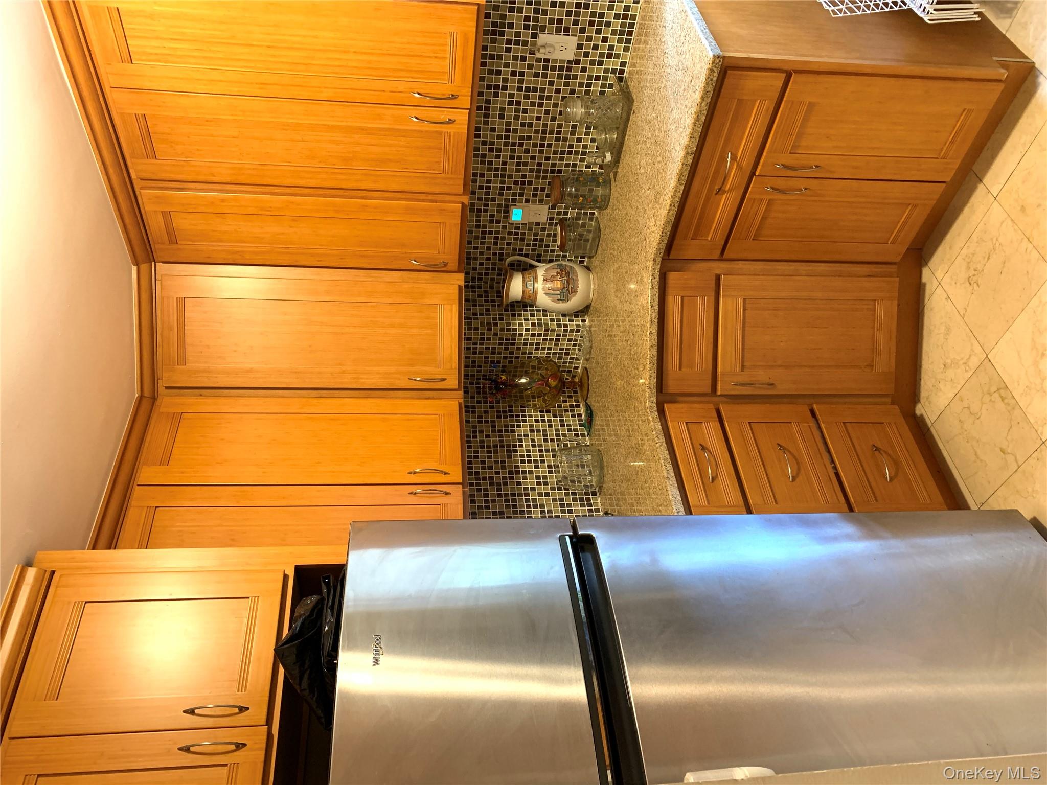 30 Davenport Avenue, Unit 1B New Rochelle, NY 10805 - Photo 5 of 16 a kitchen with stainless steel appliances a refrigerator and a sink